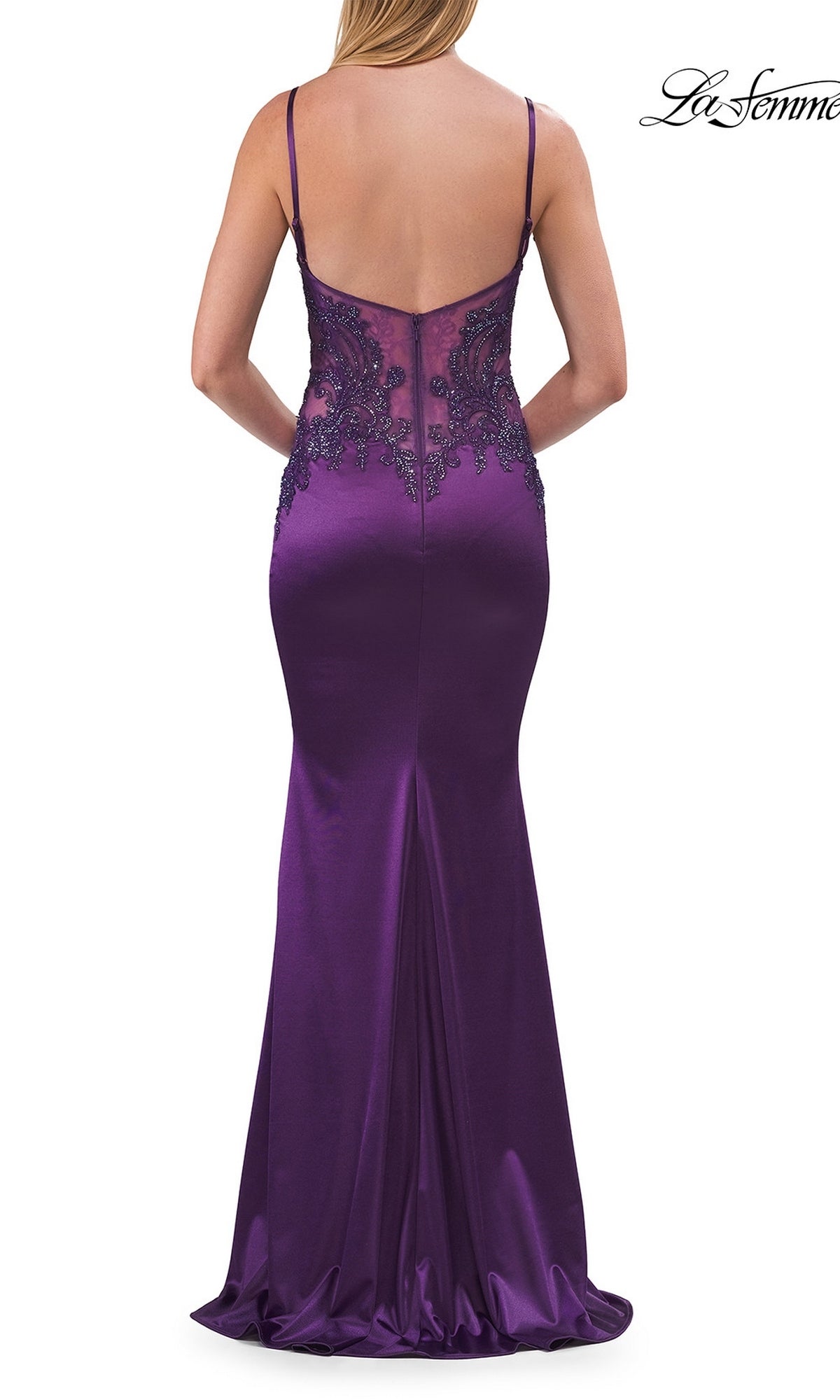 A woman is seen from behind wearing the Classic Long Satin Prom Dress: La Femme 33709, a floor-length, deep purple gown featuring thin straps and sheer beaded-lace bodice detailing on the back.